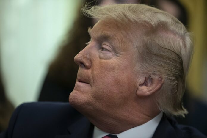President Donald Trump listens during an event on prayer in public schools, in the Oval Office of the White House, Thursday, Jan. 16, 2020, in Washington. (AP Photo/ Evan Vucci)