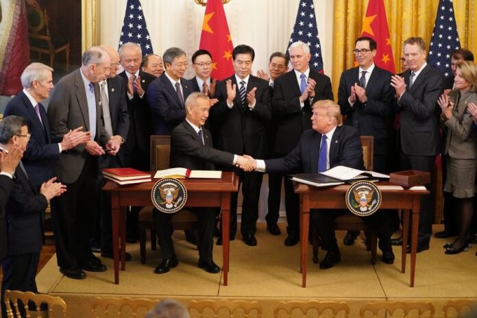 U.S. President Donald Trump and Chinese Vice Premier Liu He, who is also the chief of the Chinese side of the China-U.S. comprehensive economic dialogue, shake hands during a ceremony at the East Room of the White House in Washington D.C., the United States, Jan. 15, 2020. (Xinhua/Wang Ying)