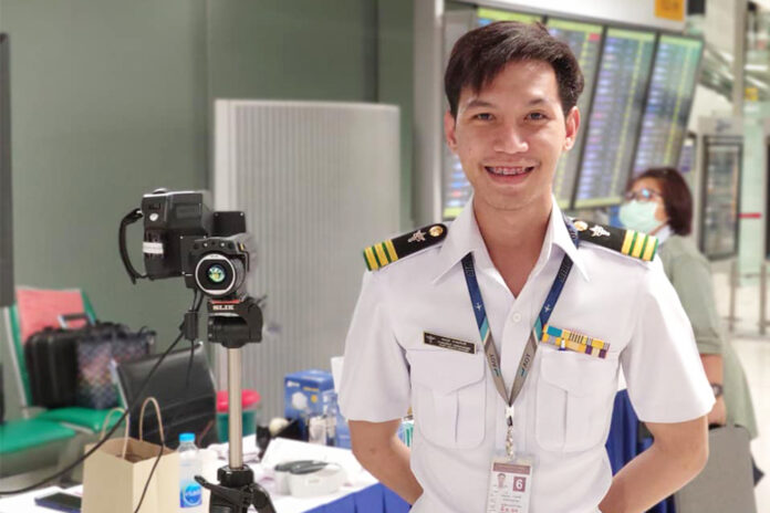 Thanawut Karapakdee stands next to a thermal camera that is used to detect a fever at a quarantine checkpoint inside Suvarnabhumi Airport. Photo: Mut Karapakdee / Facebook