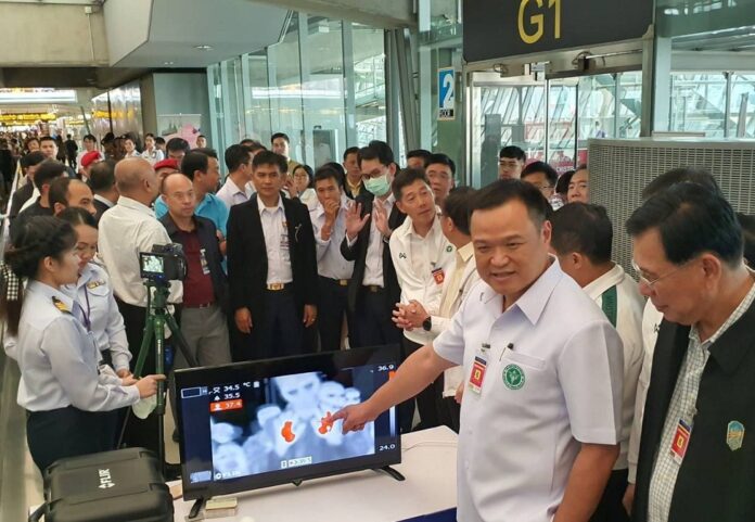 Health officials check out a device that detects the new coronavirus at Suvarnamabhumi Airport on Jan. 5, 2020.