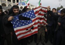 US Informs Thailand About Iraq Airstrike in Advance, MFA Says Protesters burn a U.S. flag during a demonstration over the U.S. airstrike in Iraq that killed Iranian Revolutionary Guard Gen. Qassem Soleimani, in Tehran, Iran, Jan. 3, 2020. Photo: Vahid Salemi / AP