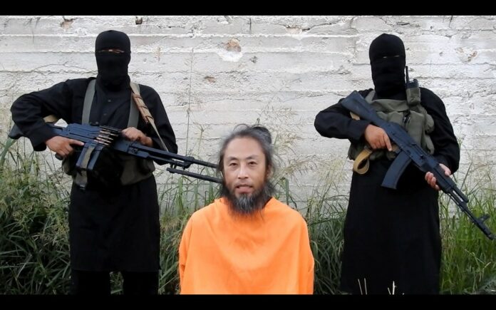 A still image captured from a video uploaded online shows Japanese journalist Jumpei Yasuda, who went missing in Syria in 2015, asking for help