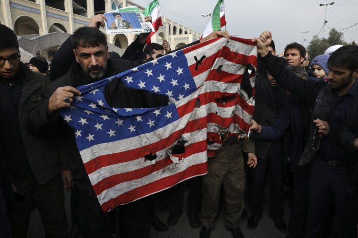 Protesters burn a U.S. flag during a demonstration over the U.S. airstrike in Iraq that killed Iranian Revolutionary Guard Gen. Qassem Soleimani, in Tehran, Iran, Jan. 3, 2020. Photo: Vahid Salemi / AP