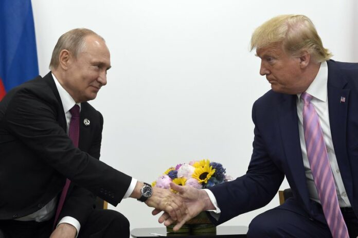 In this June 28, 2019, file photo, President Donald Trump, right, shakes hands with Russian President Vladimir Putin, left, during a bilateral meeting on the sidelines of the G-20 summit in Osaka, Japan. (AP Photo/Susan Walsh, File)