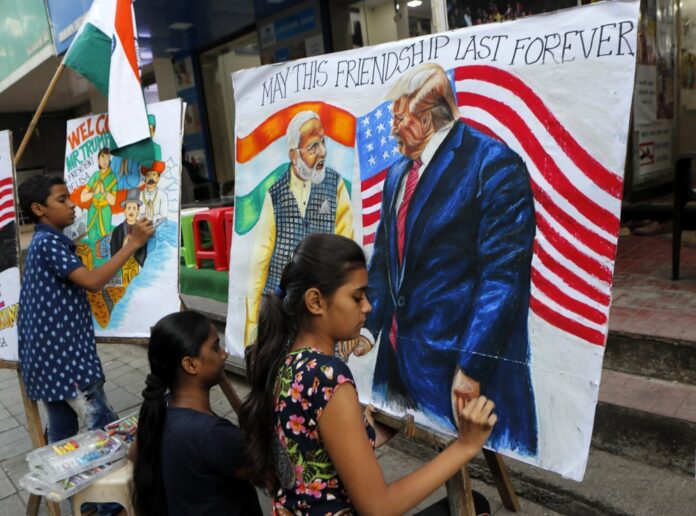 In this Feb. 21, 2020, file photo, children from an art school make paintings of U.S. President Donald Trump and India Prime Minister Narendra Modi ahead of Trump's India visit, in Mumbai, India. (AP Photo/Rajanish Kakade, File)
