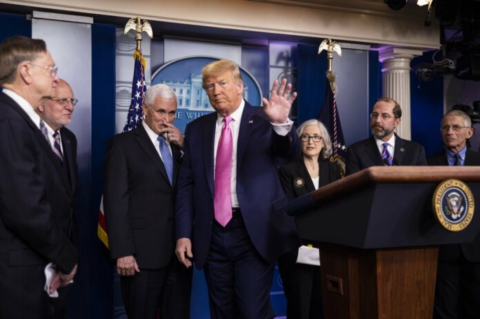 President Donald Trump with members of the president's coronavirus task force waves as he ends a news conference at the Brady press briefing room of the White House, Wednesday, Feb. 26, 2020, in Washington. (AP Photo/Manuel Balce Ceneta)