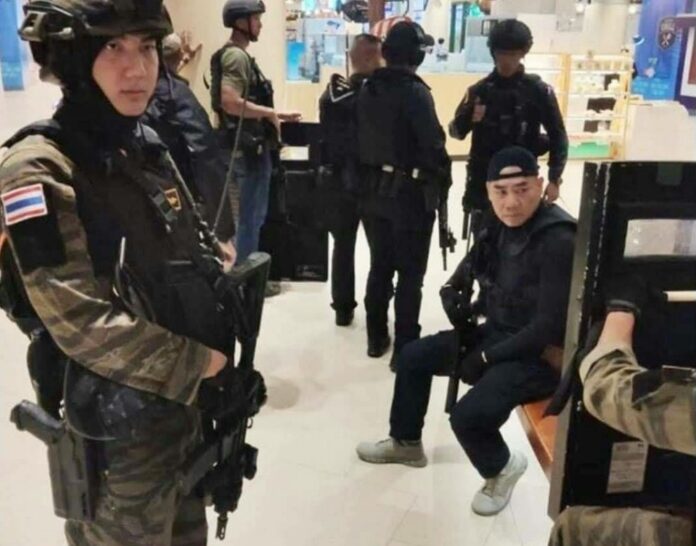 Photo released by the police shows a group of police officers taking a rest after mass shooter Sgt. Jakkrapanth Thomma was killed in a shootout inside Terminal 21 shopping mall in Korat City, Feb. 9, 2020.