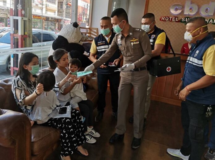 Police hand out face masks to Chinese tourists in Surat Thani province on Jan. 30, 2020.