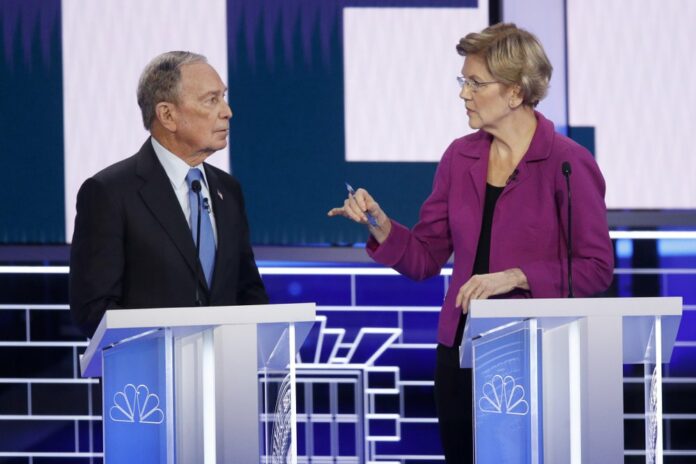 Democratic presidential candidates, former New York City Mayor Mike Bloomberg, left, and Sen. Elizabeth Warren, D-Mass., talk before a Democratic presidential primary debate Wednesday, Feb. 19, 2020, in Las Vegas, hosted by NBC News and MSNBC. (AP Photo/John Locher)