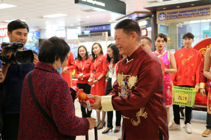 Officials greet a Chinese tourist arriving at Chiang Mai Airport on Jan. 24, 2020.