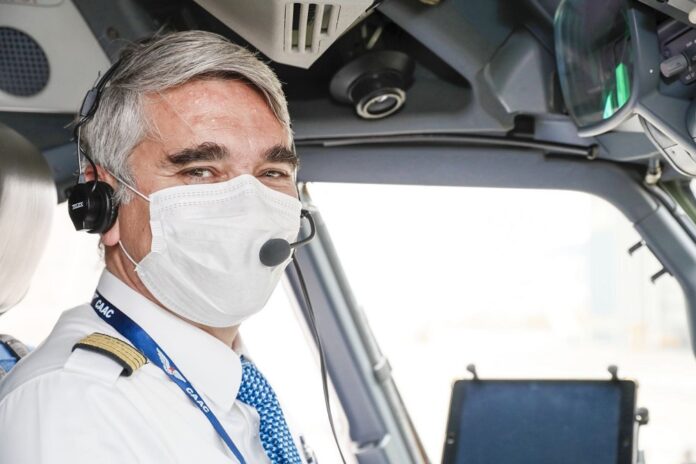 Myles Bernard Weston, an Australian captain with Xiamen Airlines, sits inside the cockpit of an airplane. (Photo provided by Xiamen Airlines)