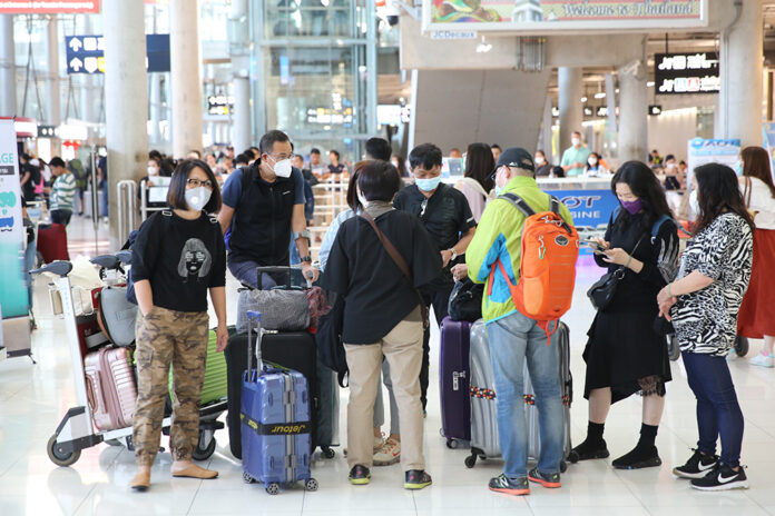 A file photo of tourists wearing face masks at Suvarnabhumi Airport.