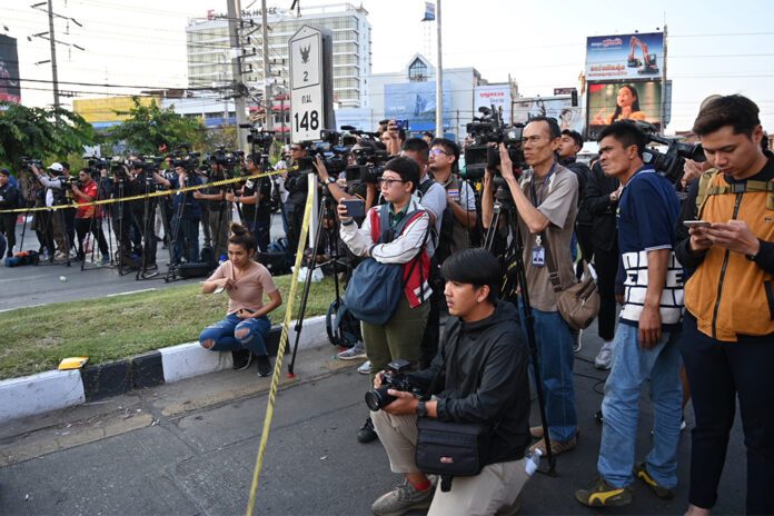 A crowd of journalists take position behind the police line near Terminal 21 Korat mall on Feb. 9, 2020.