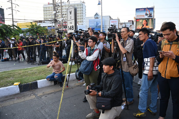 A crowd of journalists take position behind the police line near Terminal 21 Korat mall on Feb. 9, 2020. A crowd of journalists take position behind the police line near Terminal 21 Korat mall on Feb. 9, 2020.