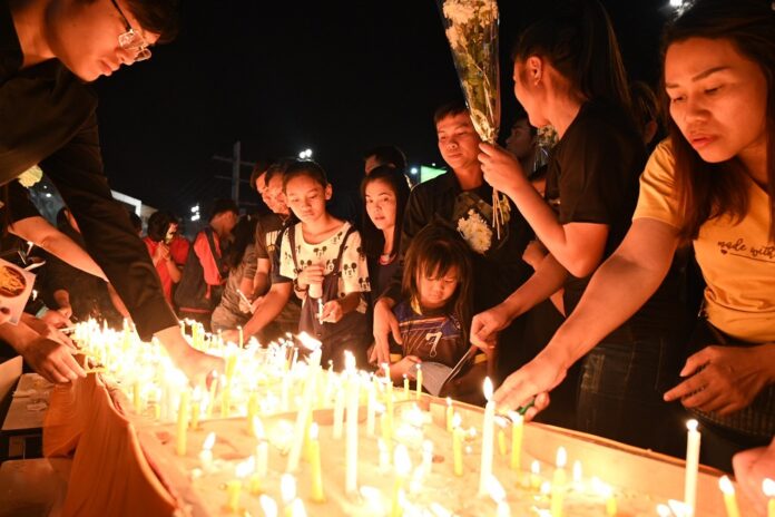 Mourners lay down flowers in memory of the 29 victims killed in Nakhon Ratchasima mass shooting.