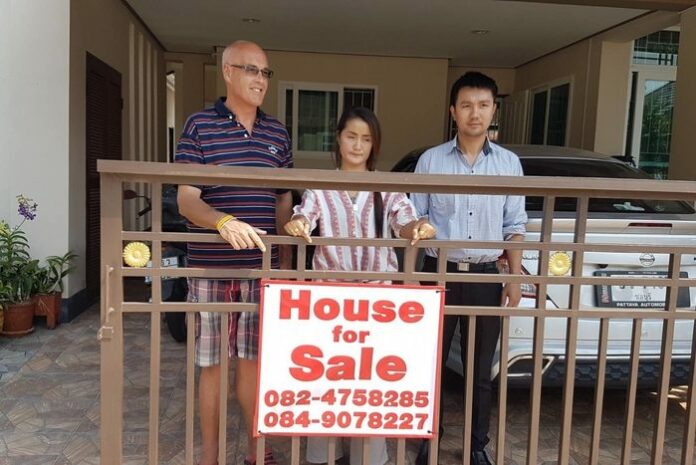 Robert Vinn, left, and his wife Duenpen Vinn, center, at their house in Rayong province on Feb. 19, 2020.