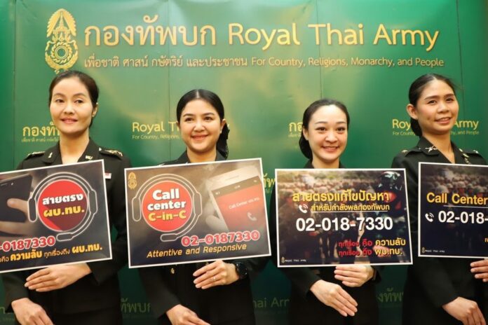 Soldiers hold signs promoting the new call center at the Internal Security Operations Command headquarters on Feb. 19, 2020.