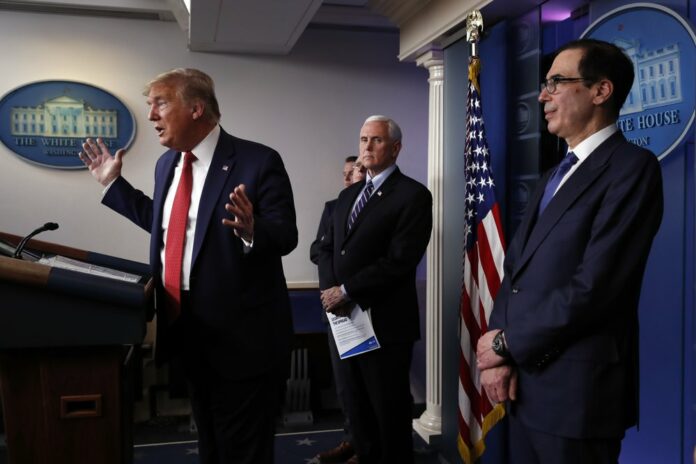President Donald Trump speaks about the coronavirus in the James Brady Briefing Room, Wednesday, March 25, 2020, in Washington as Vice President Mike Pence and Treasury Secretary Steven Mnuchin listen. Photo: Alex Brandon / AP