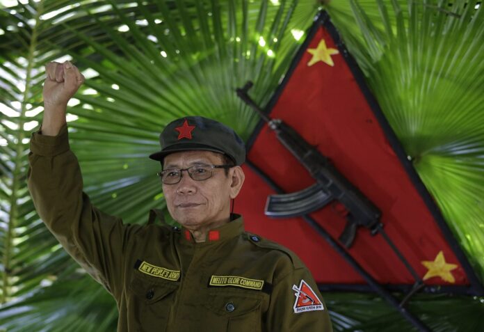 In this photo taken Nov. 23, 2016, New People's Army regional rebel commander and spokesman Jaime Padilla, who uses the nom de guerre Comrade Diego, raises his clenched fist after a clandestine news conference in a encampment tucked in the harsh wilderness of the Sierra Madre mountains southeast of Manila, Philippines. (AP Photo/Aaron Favila)