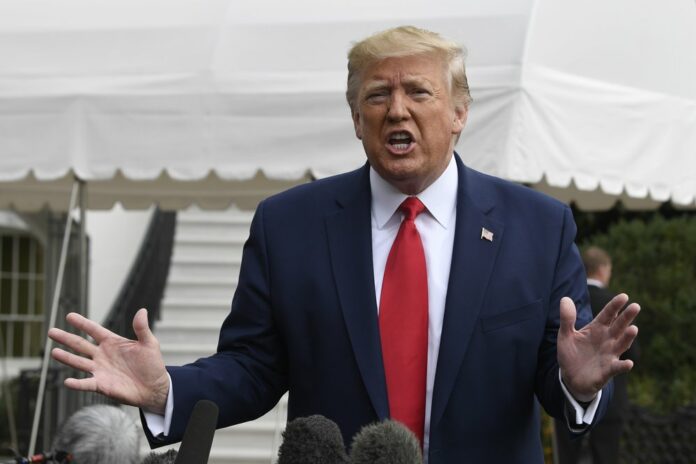 In this Oct. 25, 2019, photo, President Donald Trump talks to reporters on the South Lawn of the White House in Washington. (AP Photo/Susan Walsh)