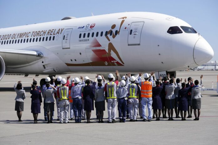 Ground crews of Japanese airlines wave to the special