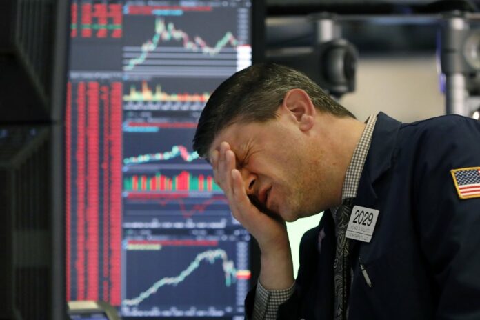 Trader Michael Gallucci works at his post on the floor of the New York Stock Exchange, Wednesday, March 11, 2020. (AP Photo/Richard Drew)