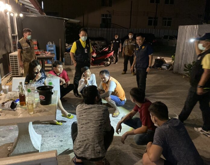 Security officers raid a bar in Chonburi province for violating a closure order of restaurants and bars on March 21, 2020.