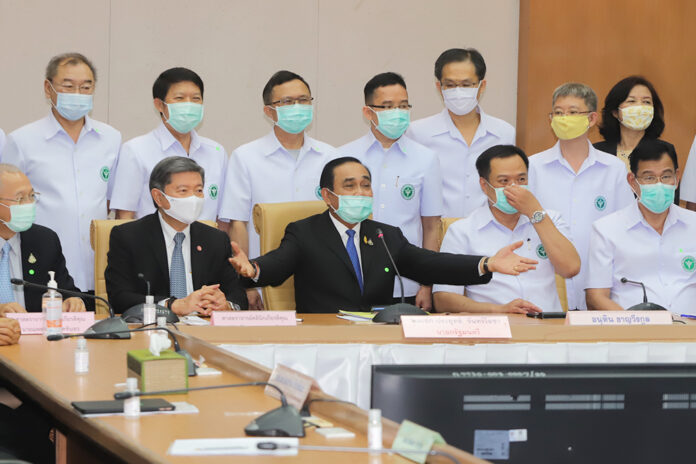 Prime Minister Prayut Chan-o-cha, center, during a meeting with health officials at the Ministry of Public Health on March 19, 2020.