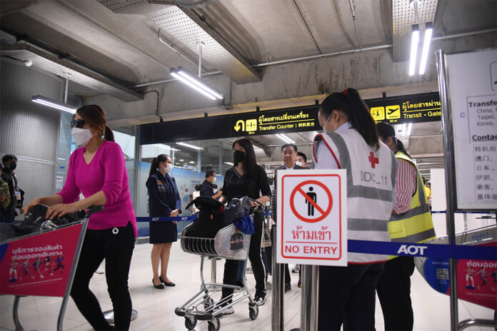 Travelers go through a health quarantine checkpoint at Suvarnabhumi Airport on March 4, 2020.