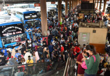 Worker Who Left Bangkok During Travel Rush Tests Positive for Virus Mo Chit Bus Terminal crowded with people taking buses back to their hometowns on March 22, 2020.
