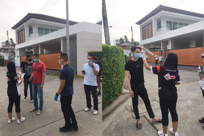 Health officials in Phuket use a thermometer to check the body temperature of Chinese tourists who fled their quarantine on March 26, 2020. Photo: Phuketandamannews