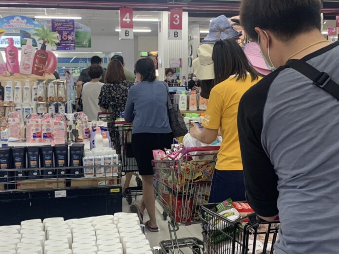 Shoppers line up at a supermarket in Bangkok on March 21, 2020. Shoppers line up at a supermarket in Bangkok on March 21, 2020.