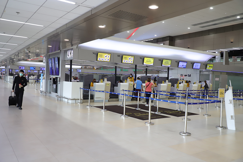 Nearly empty check-in counters at Don Mueang International Airport.