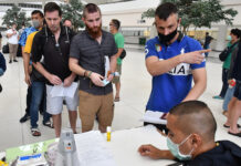 Stranded Foreigners Ordered to File for Extensions at Immigration People queue up in front of the Immigration Bureau in Chaengwattana Government Complex on March 25, 2020.