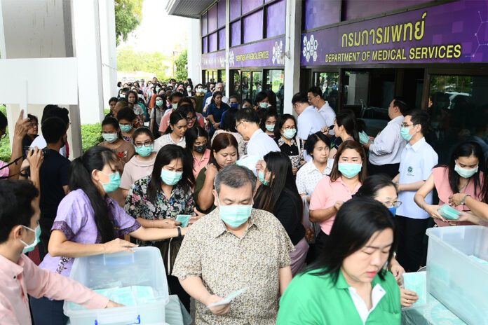 People line up to get a free packet of face masks at the Department of Medical Services in Nonthaburi province on March 3, 2020.