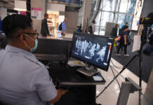 Thailand Reports First COVID-19 Fatality in 97 Days A quarantine officer screens passengers at the arrival hall of Suvarnabhumi Airport on March 4, 2020.