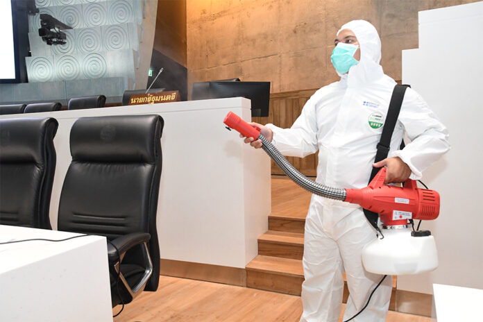 A health worker disinfects the Parliament building on Feb. 28, 2020.