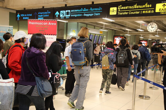 Travelers go through a health quarantine checkpoint at Suvarnabhumi Airport.
