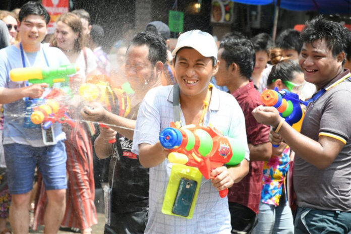 A reveller fires his watergun during Songkran festival on Khaosan Road on April 15, 2019.