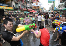 No Plan to Cancel Songkran, Tourism Chief Says Revelers engage in a waterfight on Khaosan Road during the 2019 Songkran festival.