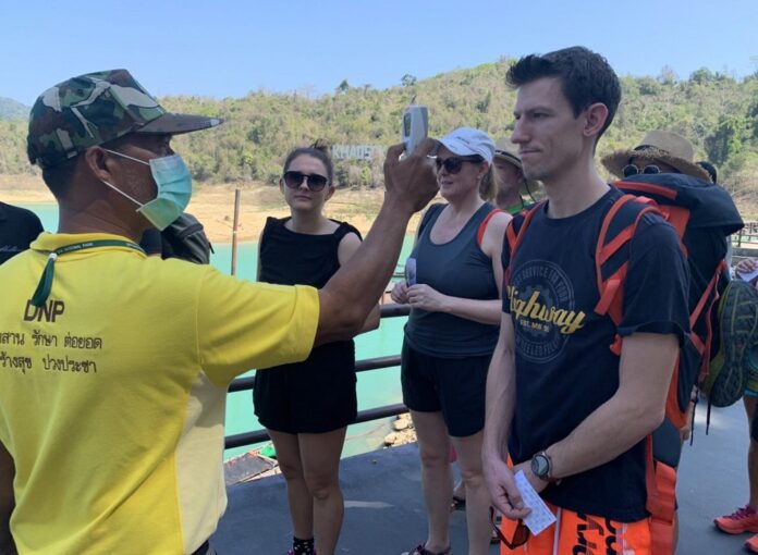 Tourists receive a body temperature check on March 15, 2020, in Surat Thani province.