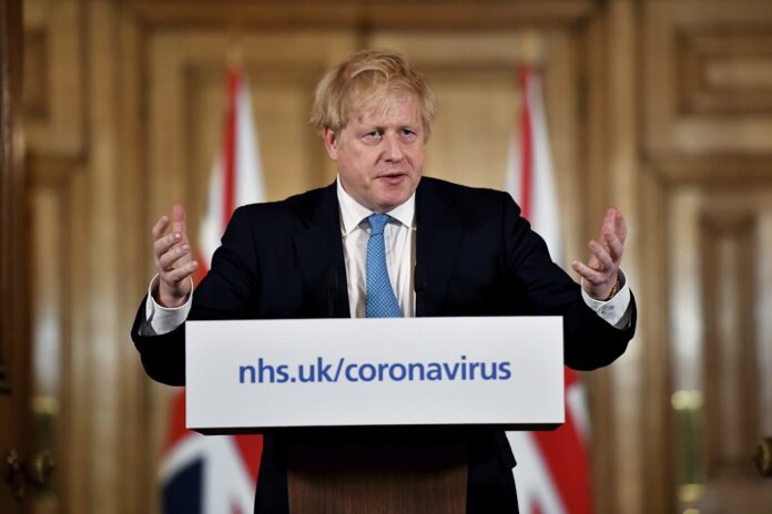 Britain's Prime Minister Boris Johnson gestures, during a coronavirus news conference at 10 Downing Street, in London, Thursday, March 19, 2020. (Leon Neal/Pool Photo via AP)