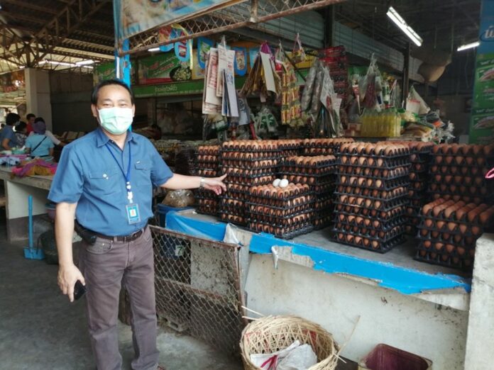 A man points to stacks of eggs in Lampang province on March 29, 2020