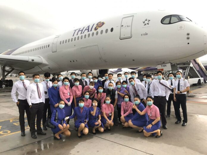 Thai Airways crew pose for photos before departing from Rome, Italy, on March 14, 2020.