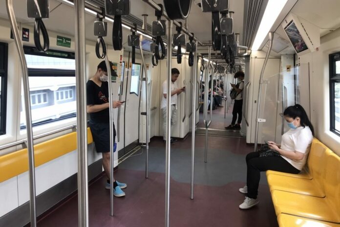 Commuters wear face masks on skytrain on March 17, 2020.