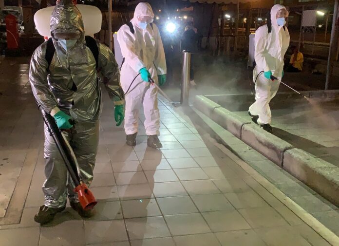 Soldiers and volunteers spray disinfectants in Bangkok on March 19, 2020.