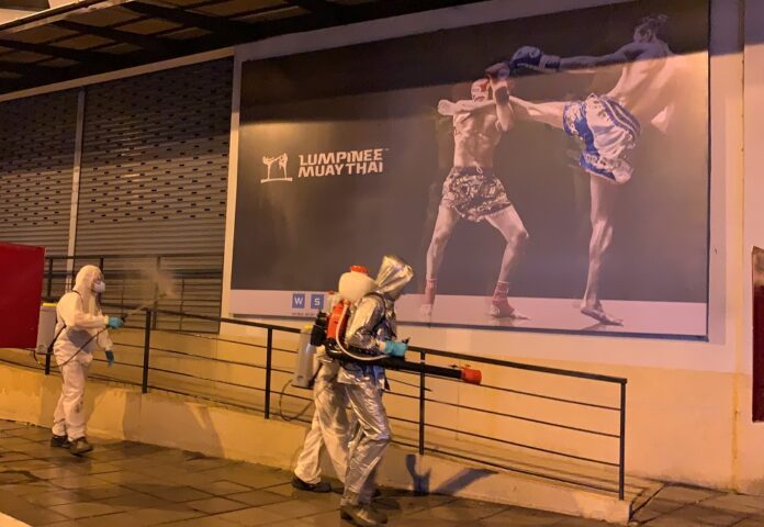 Workers disinfect Lumpinee Boxing Stadium on March 20, 2020.
