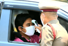A Mega-List for Travel Disruptions During State of Emergency A man gets his temperature checked at a checkpoint in Bangkok on March 26, 2020.