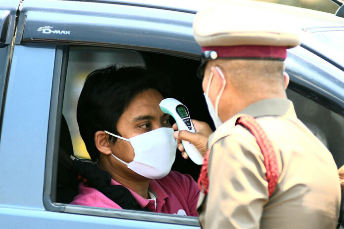 A man gets his temperature checked at a checkpoint in Bangkok on March 26, 2020. A man gets his temperature checked at a checkpoint in Bangkok on March 26, 2020.