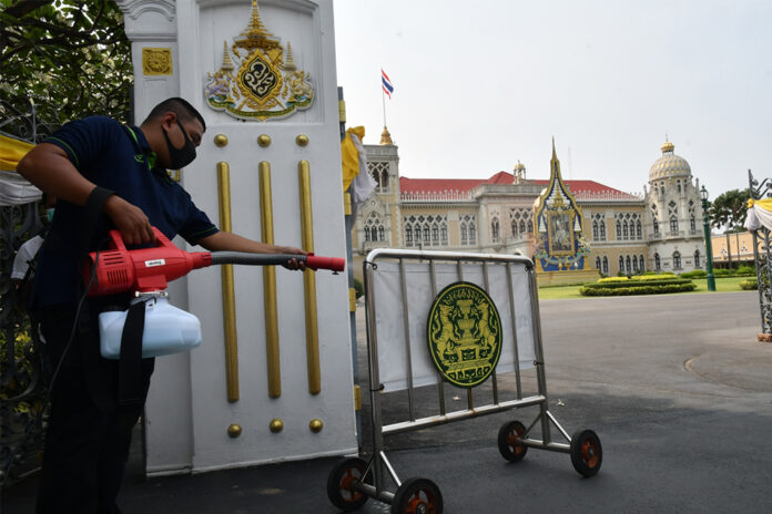 A worker disinfects a guardhouse at the Government House on March 18, 2020.
